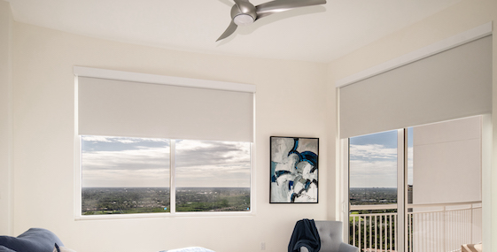 Beige blackout shades in bedroom over window and sliding glass door