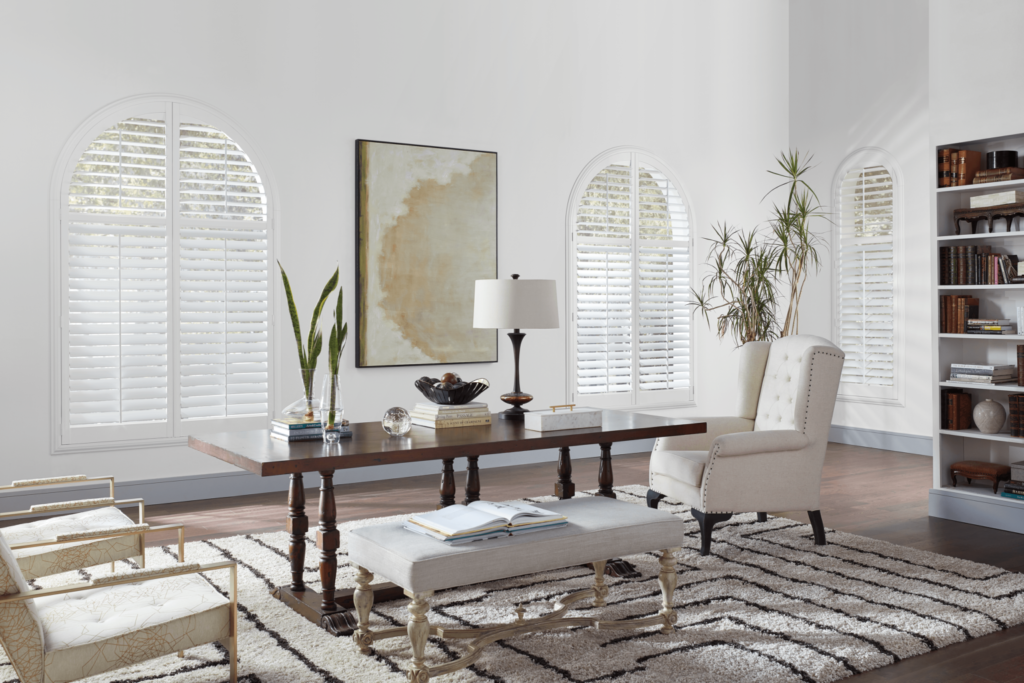 White wood shutters on curved windows