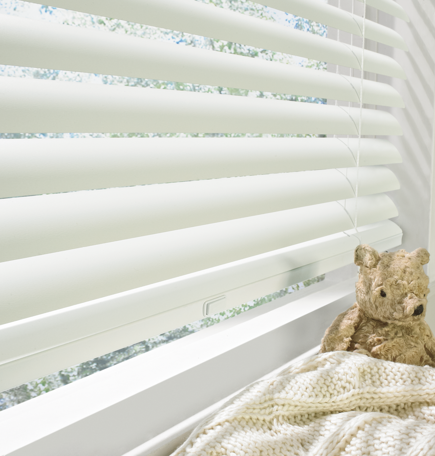 White Cordless Blinds with a teddy bear in the window sill